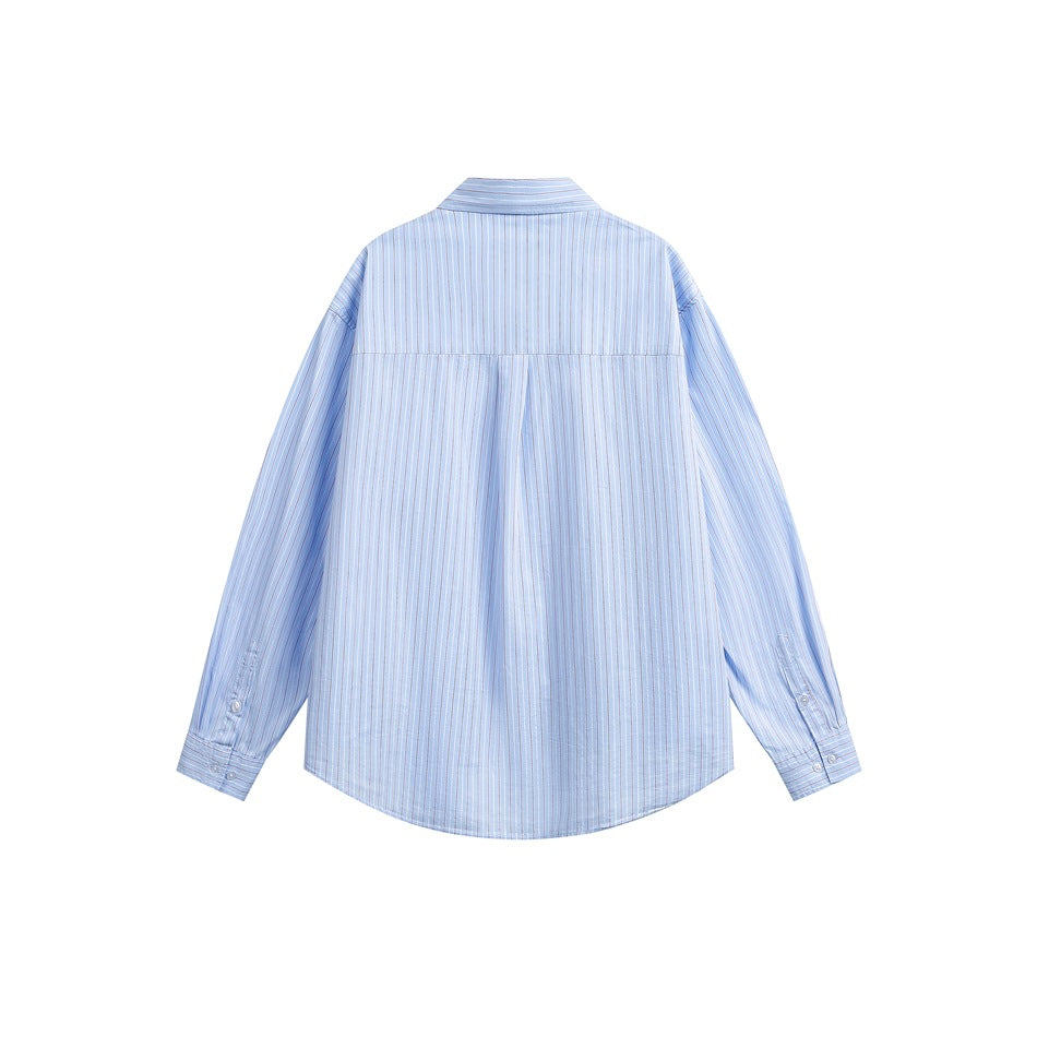Back view of light blue striped button-up shirt showing back yoke, center pleat and buttoned cuffs