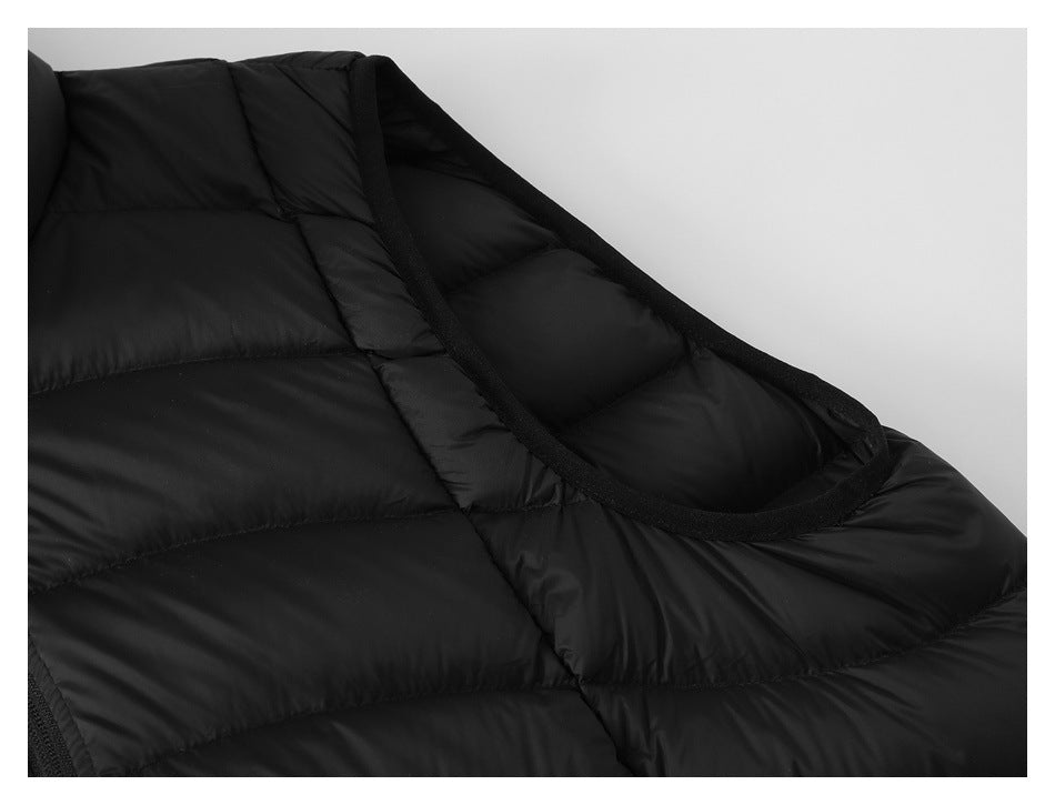 Close-up of the black vest's bound armhole and quilted shoulder area.