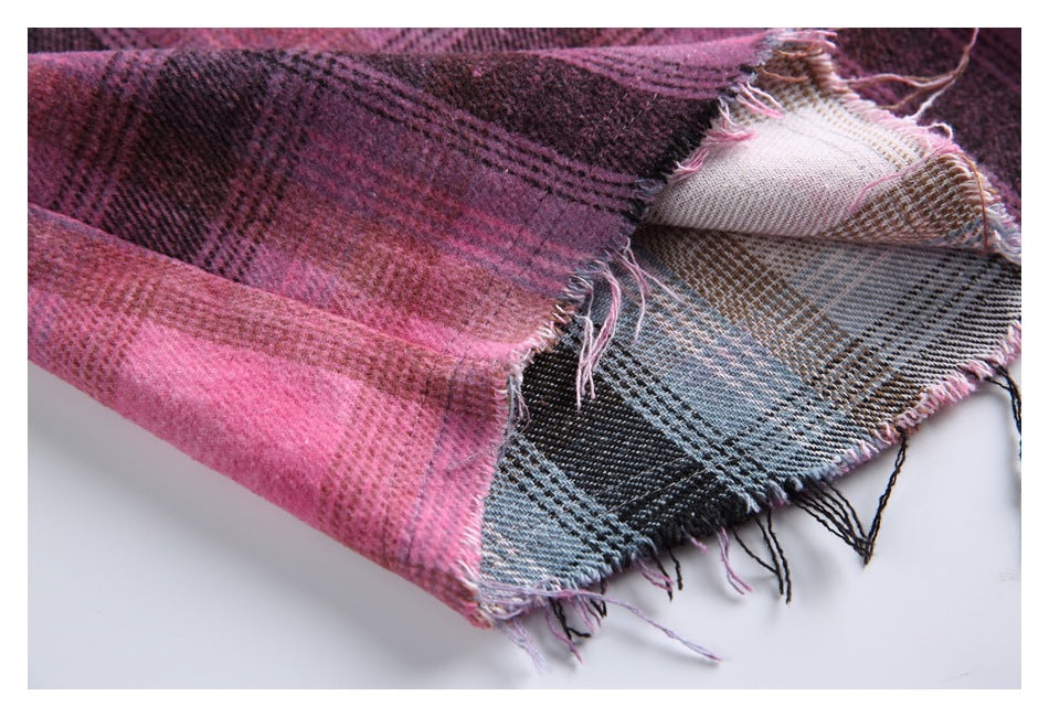 Close-up of layered pink and blue-gray plaid fabric with frayed edges.
