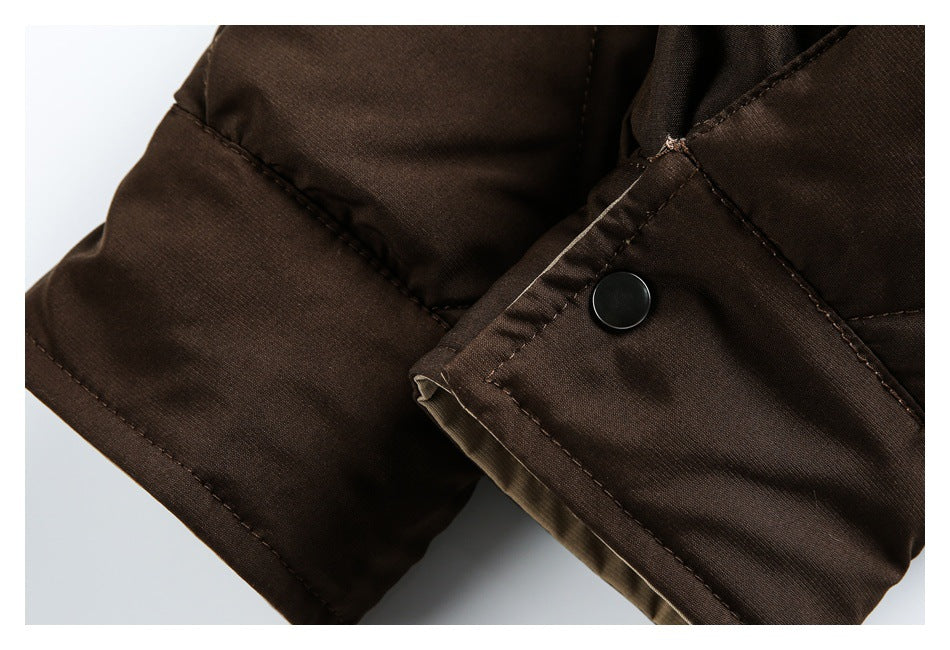 Close-up of a dark brown jacket edge with a black snap button, stitching, and olive lining visible.