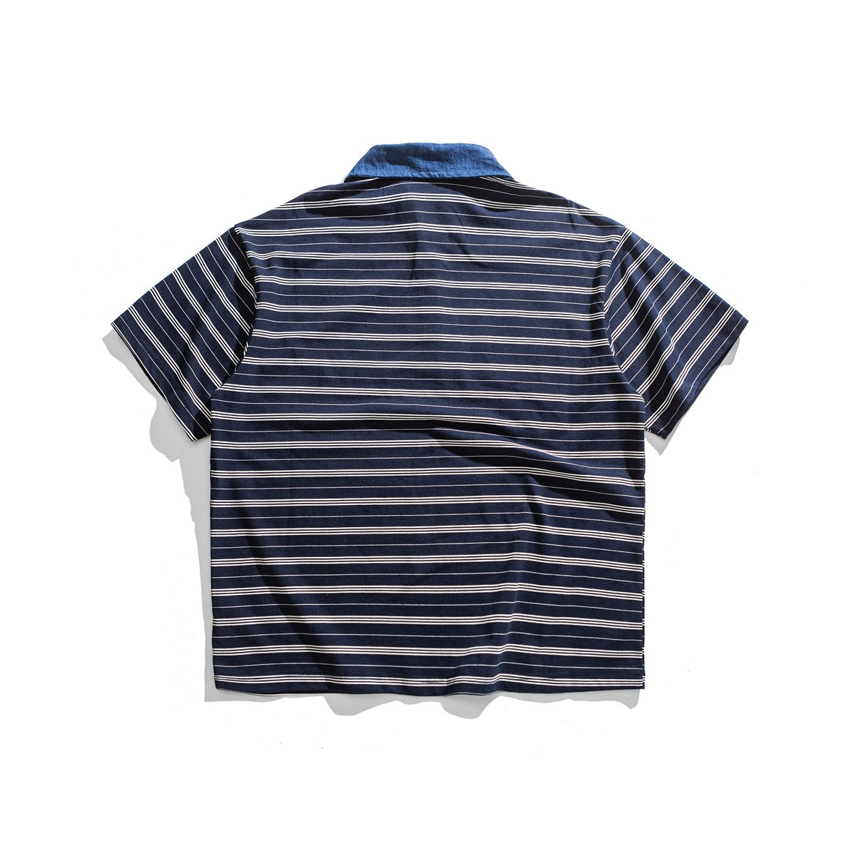 Back view of a navy short-sleeve shirt with thin white horizontal stripes and a blue collar.