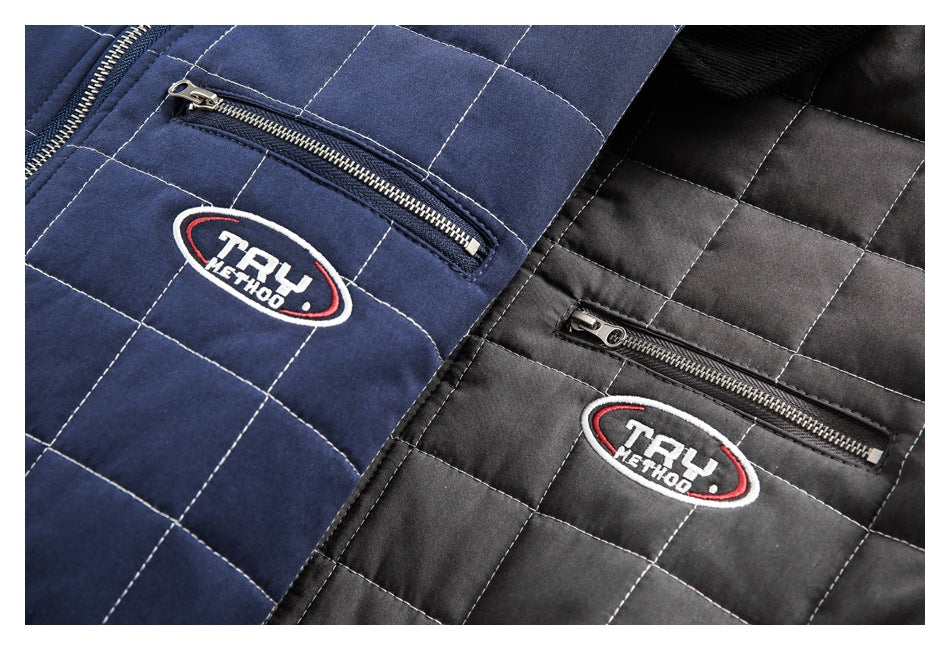 Close-up of navy and charcoal quilted jackets with zip pockets and embroidered oval patches.