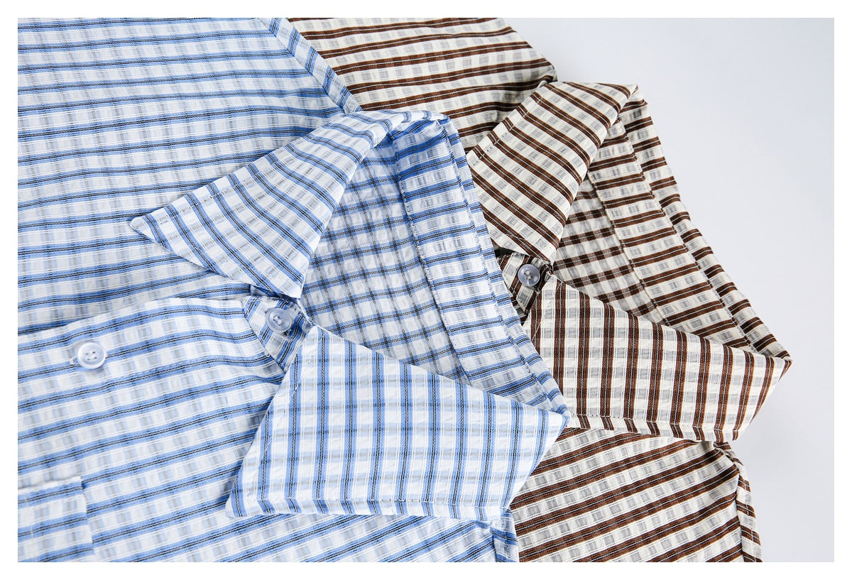Blue and brown plaid button-up shirts arranged overlapping, showing collars, buttons, and long sleeves.