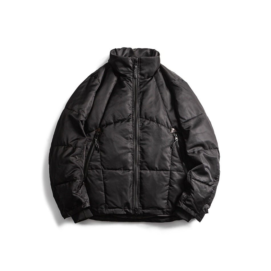 Black quilted stand-collar zip jacket with diagonal zippered pockets and ribbed cuffs, front flat lay