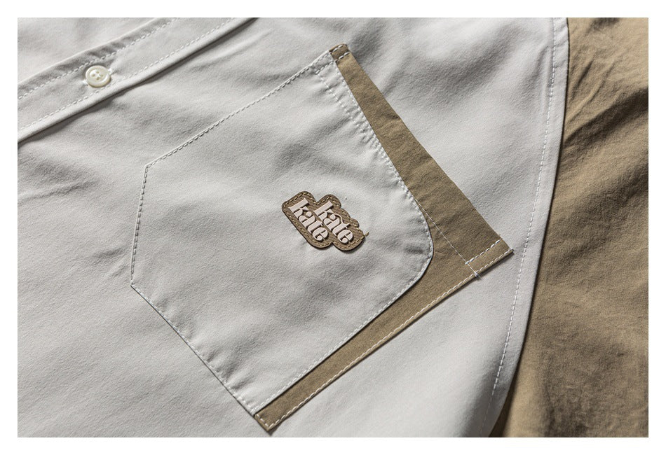 Close-up of a white shirt pocket with khaki trim and a small embroidered logo.