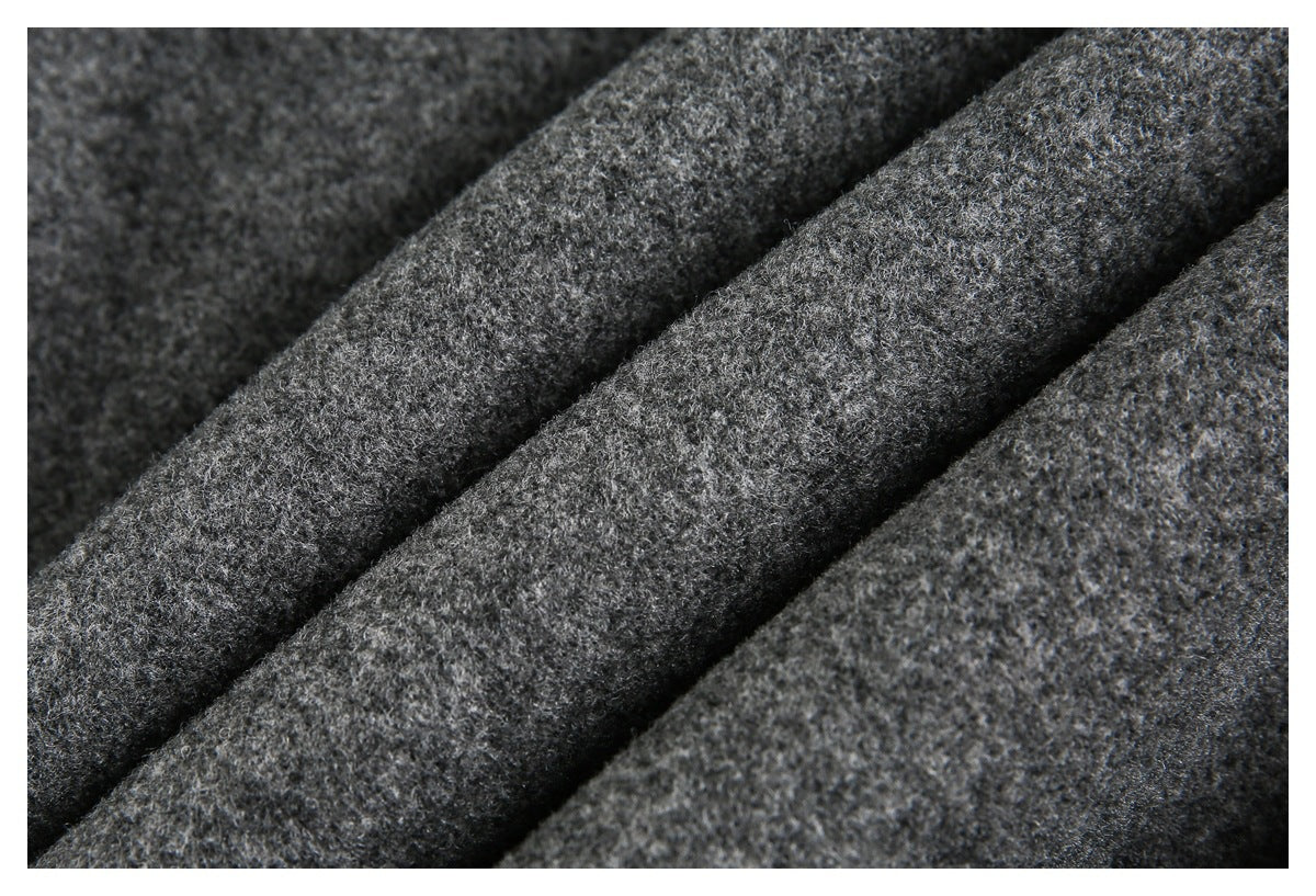 Macro view of the coat’s mottled dark gray fabric, showing its fuzzy, textured surface.