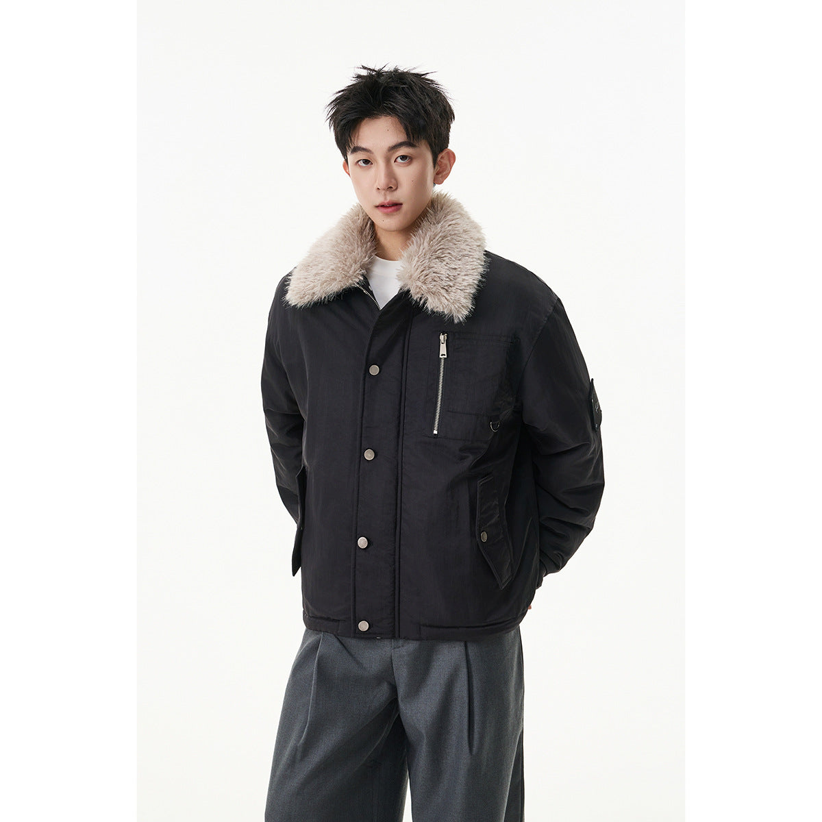 Model wearing a black jacket with a plush light collar, snap front, and zippered chest pocket.