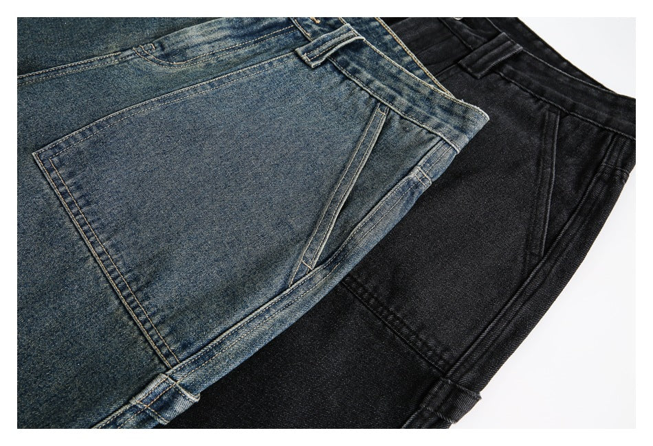 Close-up of blue and black denim shorts showing pocket stitching and denim texture.
