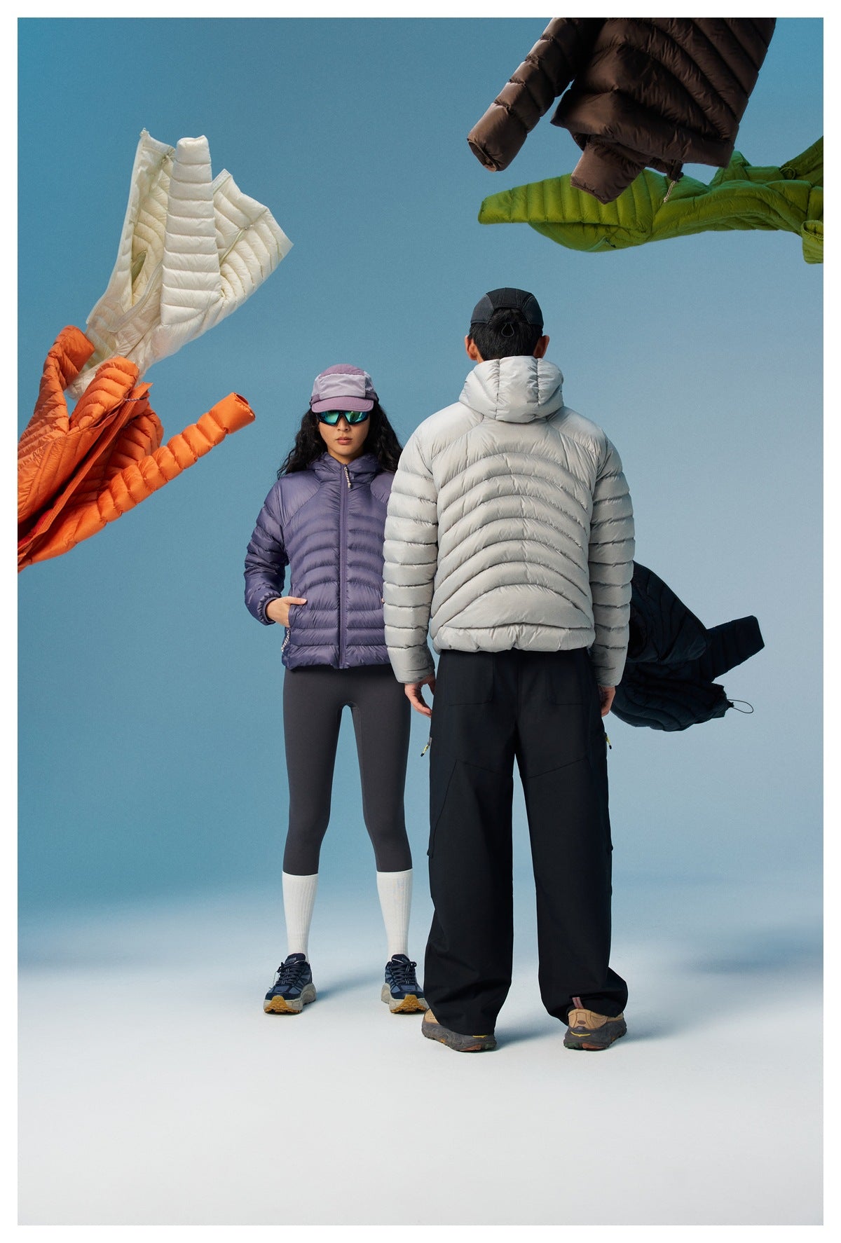 Models show the front of a purple puffer jacket and the back of a light gray hooded puffer jacket.
