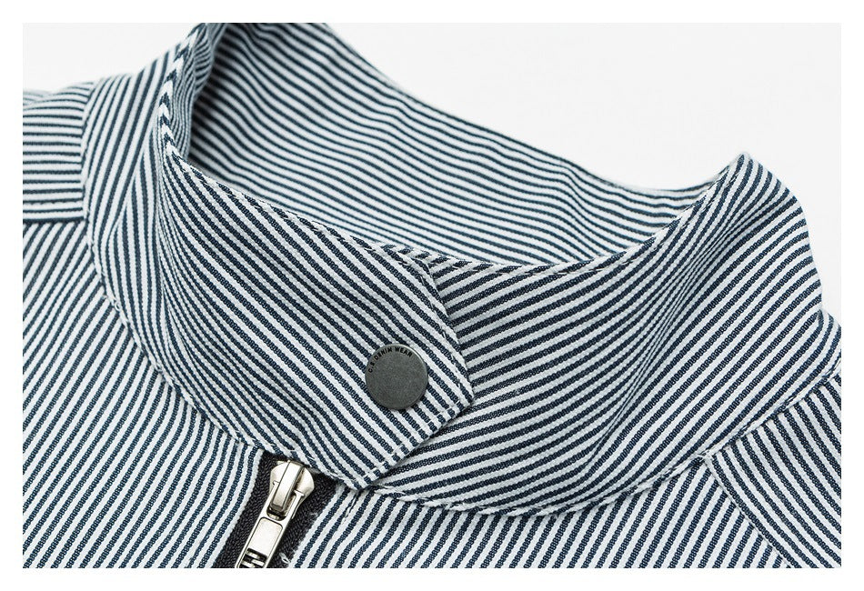 Close-up of a navy-and-white striped jacket collar, snap button and front zipper.