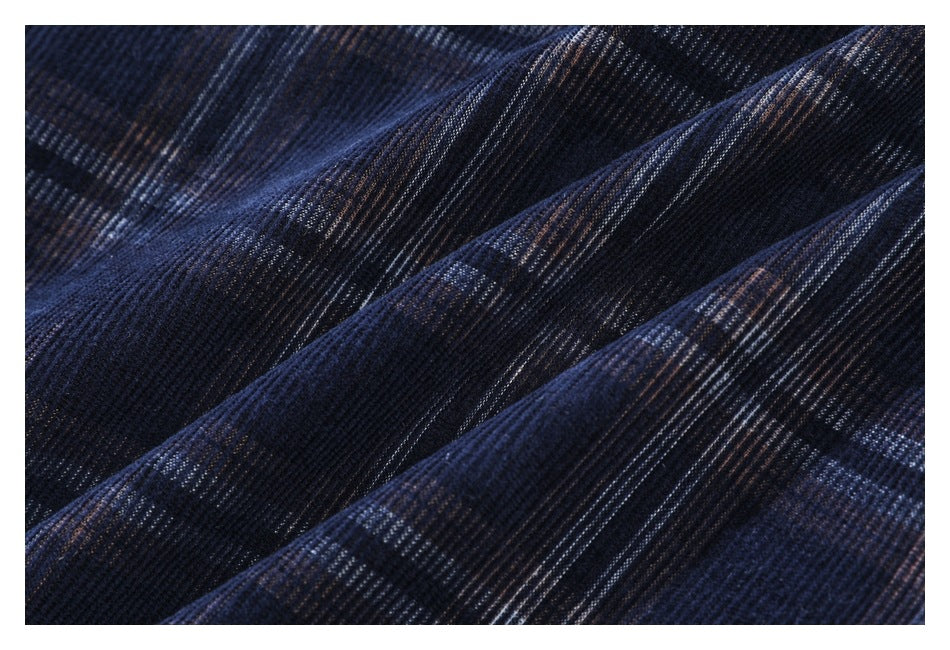 Close-up of dark navy plaid fabric showing its fine ribbed texture.