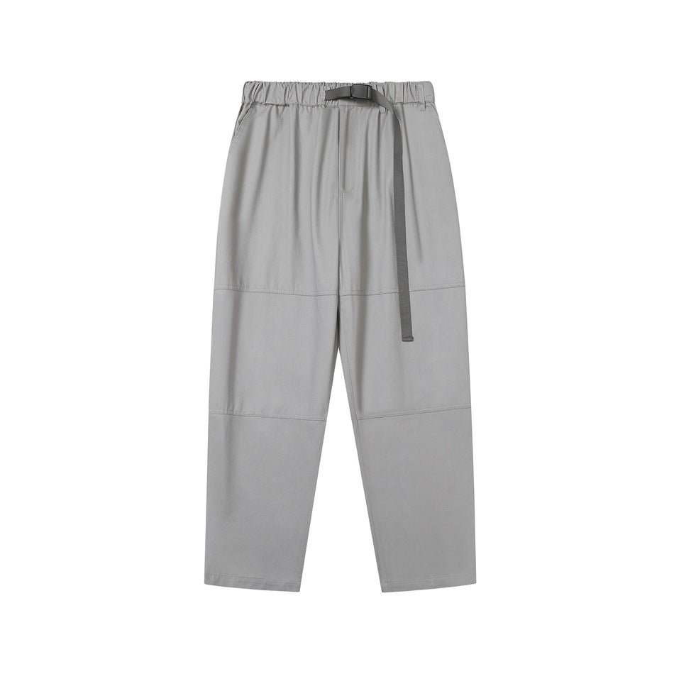 Gray elastic-waist tapered pants with buckled webbing belt, side pockets and knee seams, front flat lay