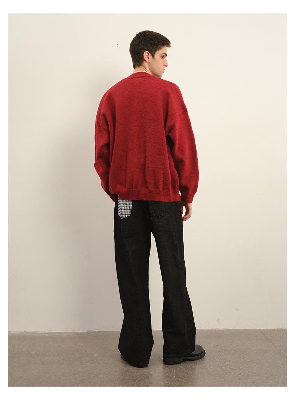 Back view of a model wearing a plain red cardigan with black trousers.