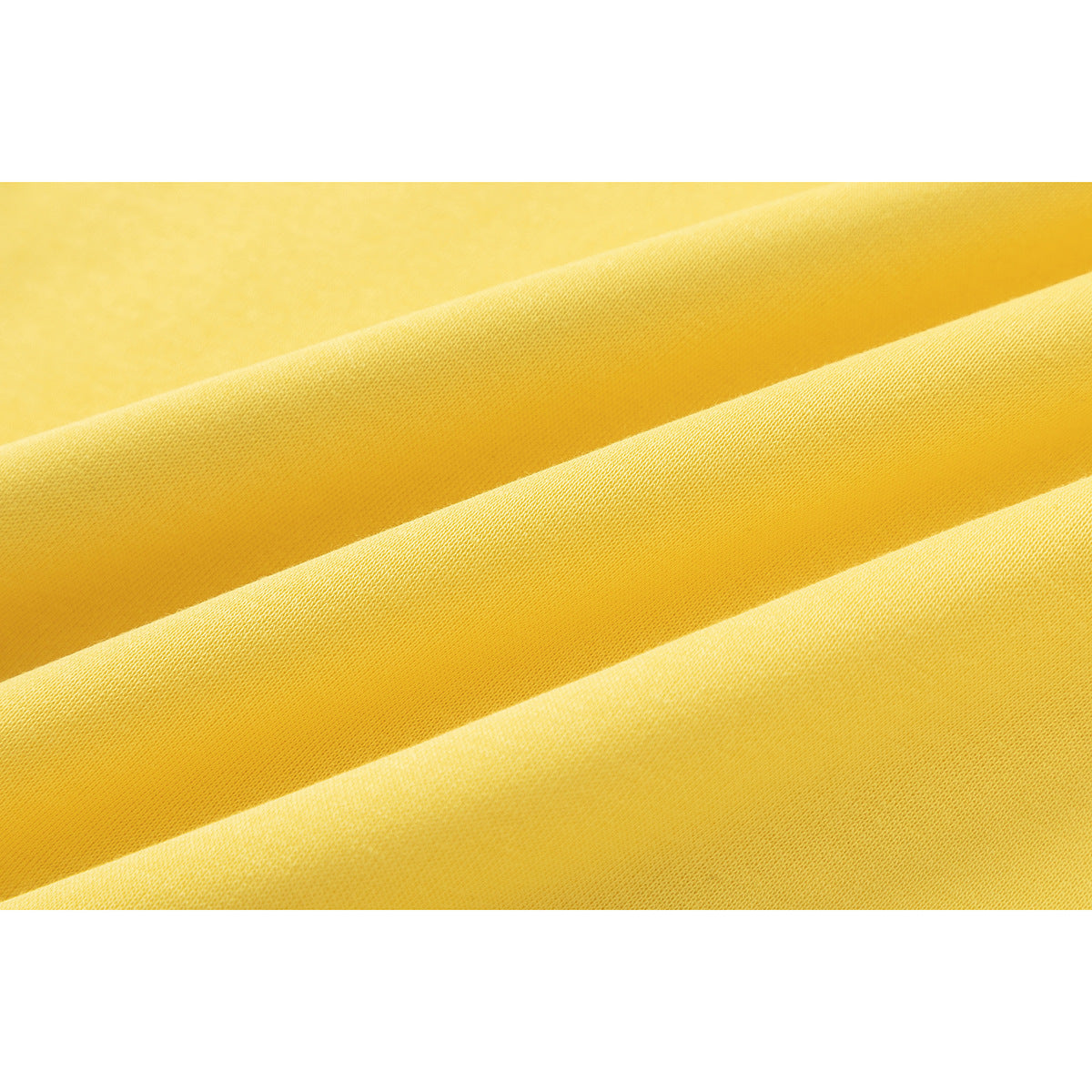 Close-up of yellow fabric arranged in soft folds, showing its fine surface texture.