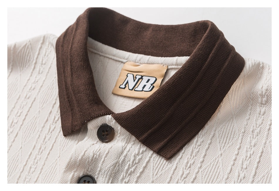 Close-up of the cream polo's dark brown collar, buttons, textured fabric, and NB neck label.