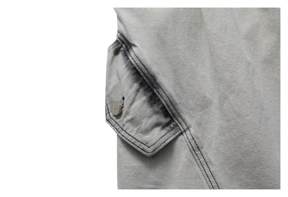 Close-up of a light gray washed denim shorts cargo pocket and dark contrast stitching.