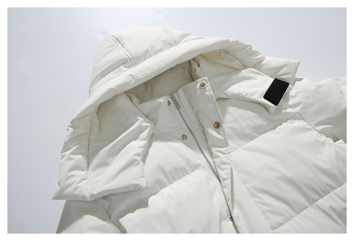 Close-up of the white puffer coat's hood, front zipper and snap placket, with a blank black sleeve patch.