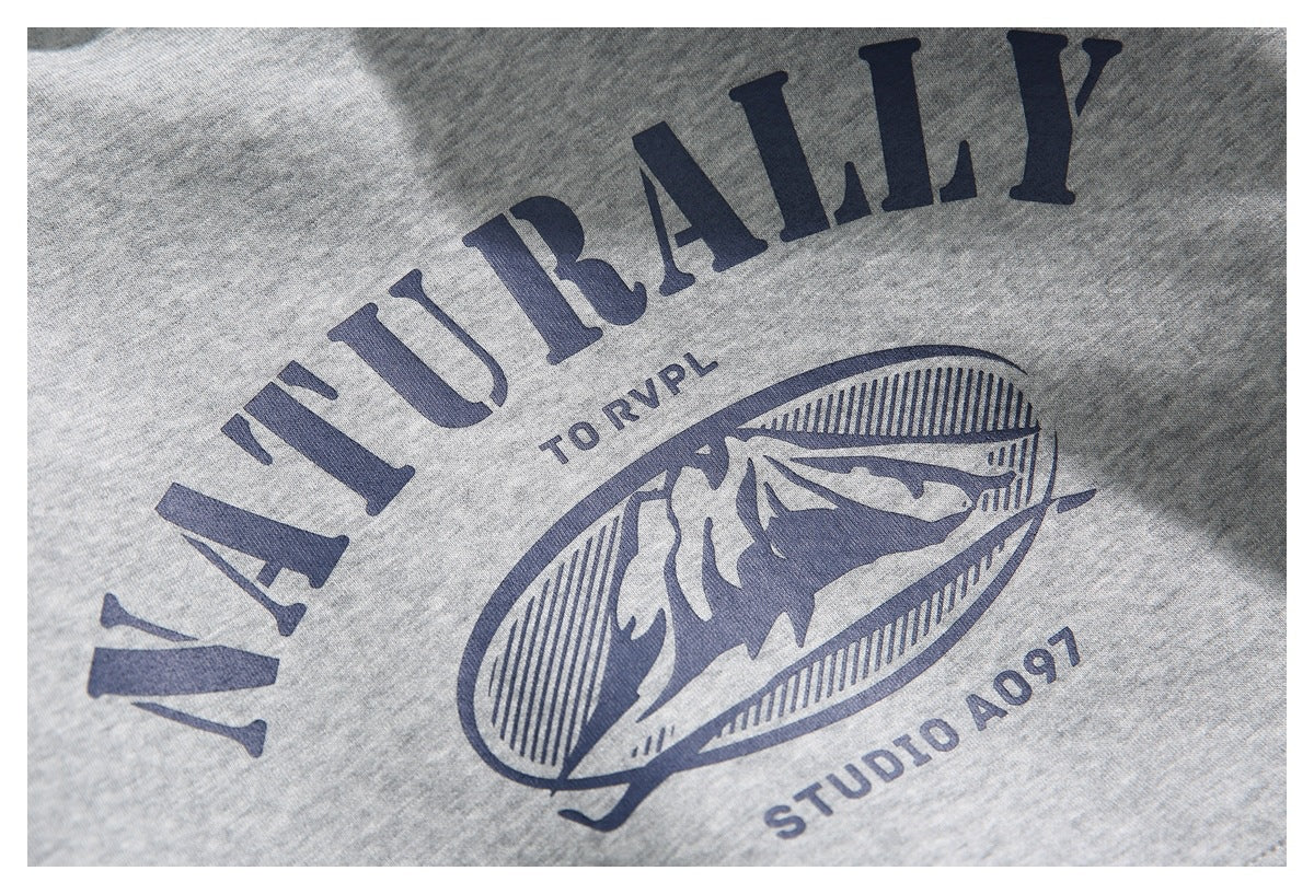 Close-up of the navy English graphic and mountain illustration printed on the gray hoodie.