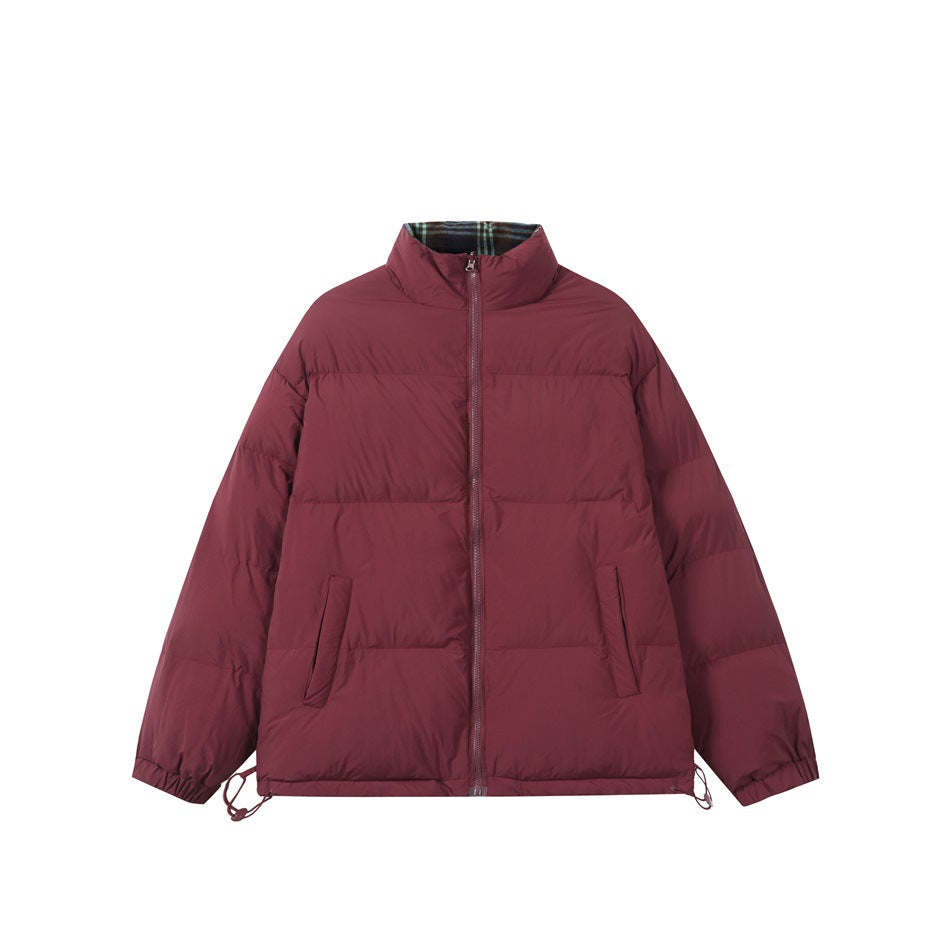 Burgundy quilted stand-collar jacket with front zipper, slanted pockets and plaid lining at the collar, flat lay