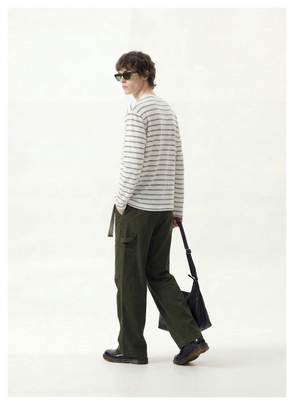 Model wearing a white Henley with thin dark stripes, shown from the back and side.