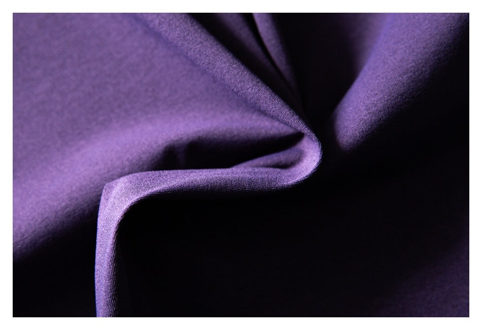 Macro view of folded purple fabric showing its surface texture and drape.