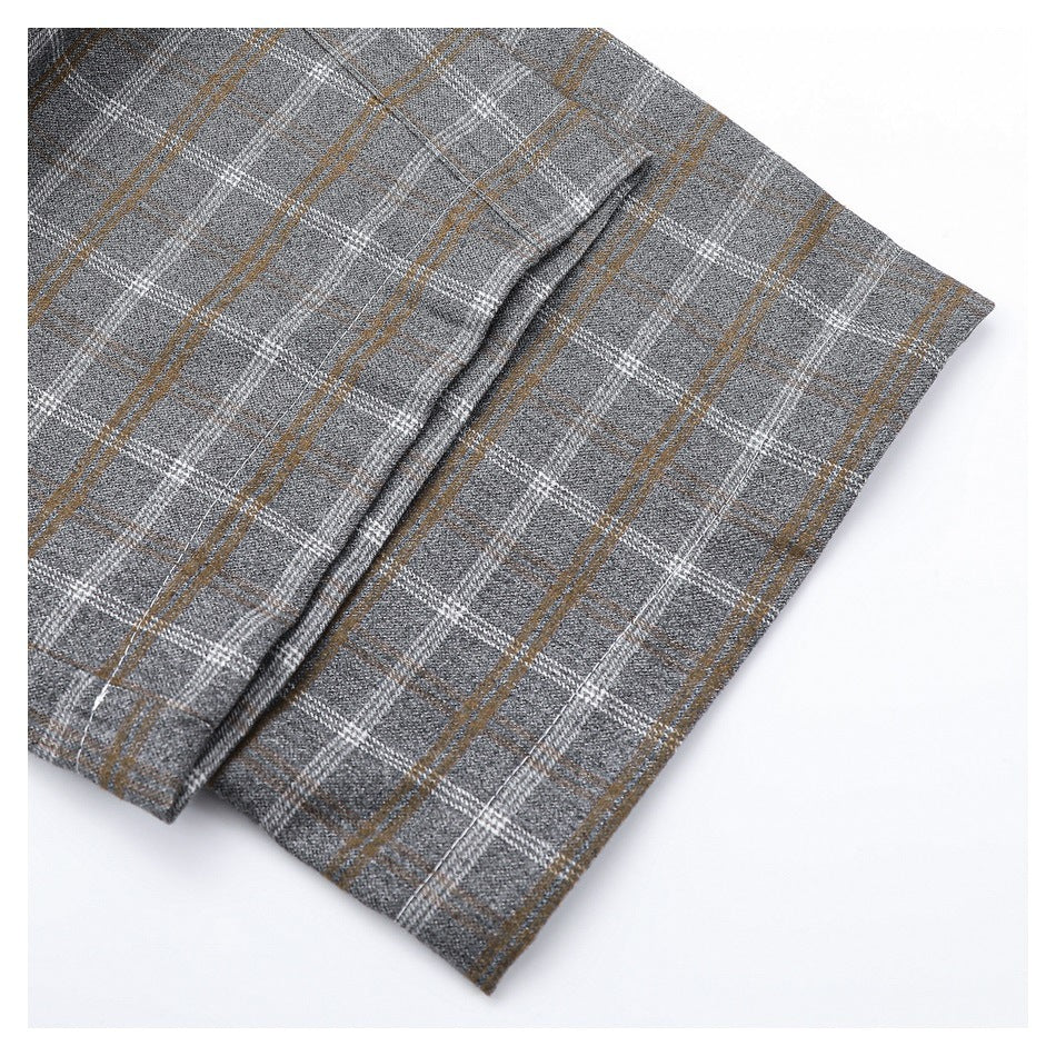 Close-up of a folded edge and seam on a gray plaid garment with white and tan lines.