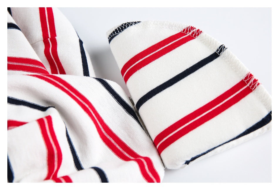 Close-up of a sleeve edge and stitching on a white shirt with red and navy stripes.