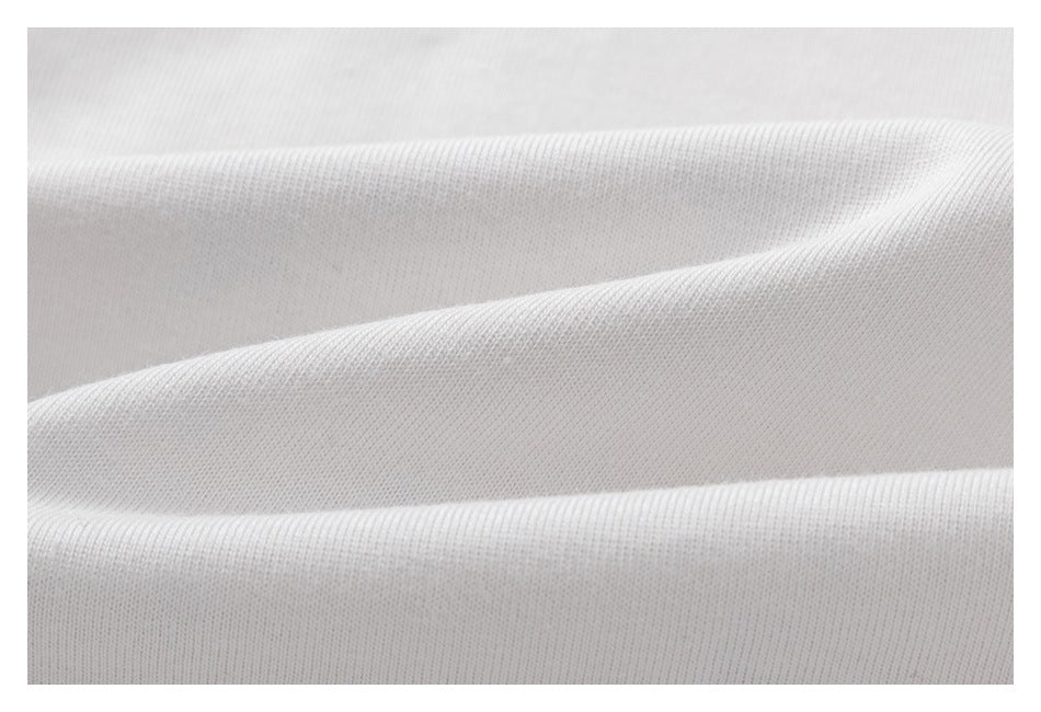 Macro view of the fine knit texture of white shirt fabric.