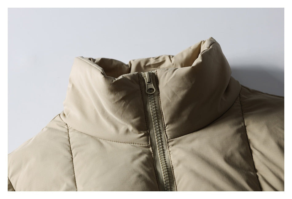Close-up of the taupe puffer jacket's padded collar and front zipper.