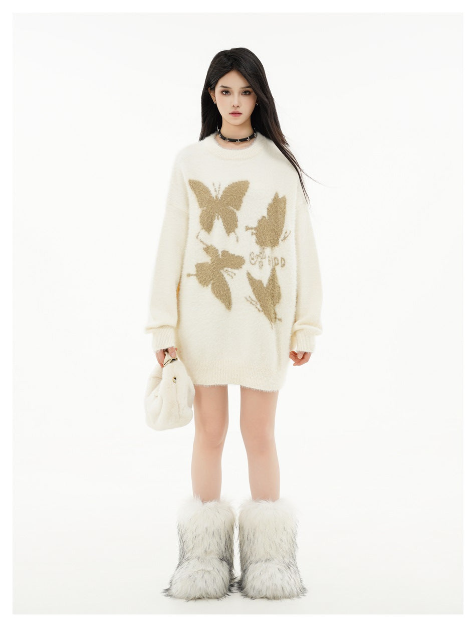 Model wearing a beige butterfly knit sweater as a short oversized look with fuzzy white boots and a plush bag