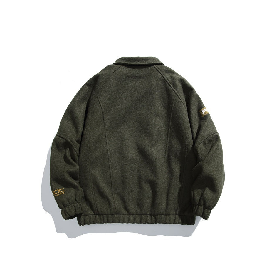 Back view of a dark olive jacket with a fold-over collar, raglan sleeves, elastic cuffs and hem, and small sleeve graphics.