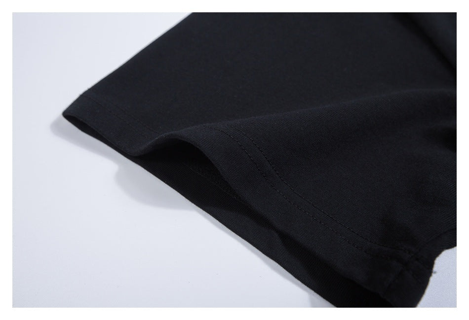 Close-up of the black T-shirt sleeve cuff and stitched edge.