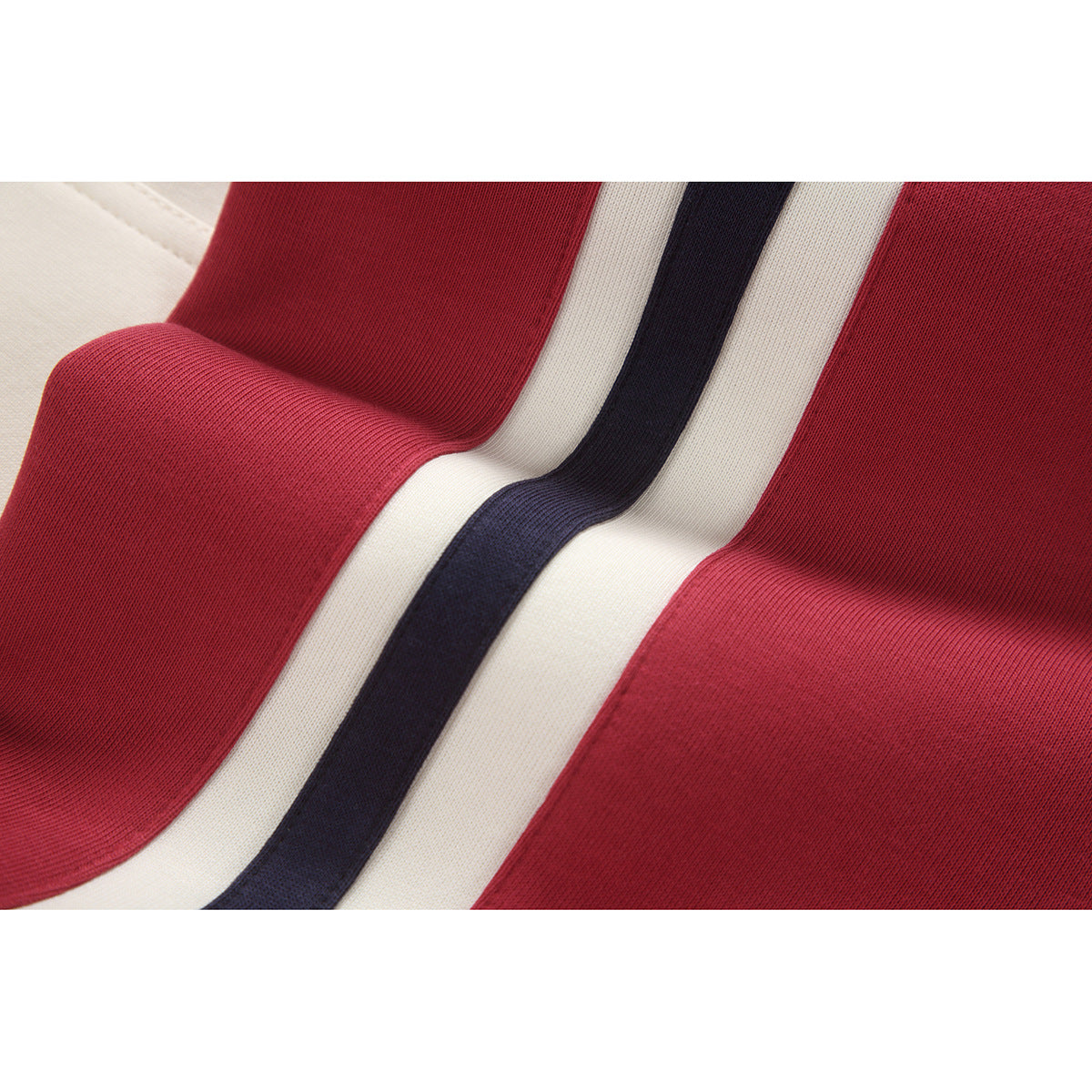 Close-up of red, cream, and navy striped fabric panels on the hoodie.