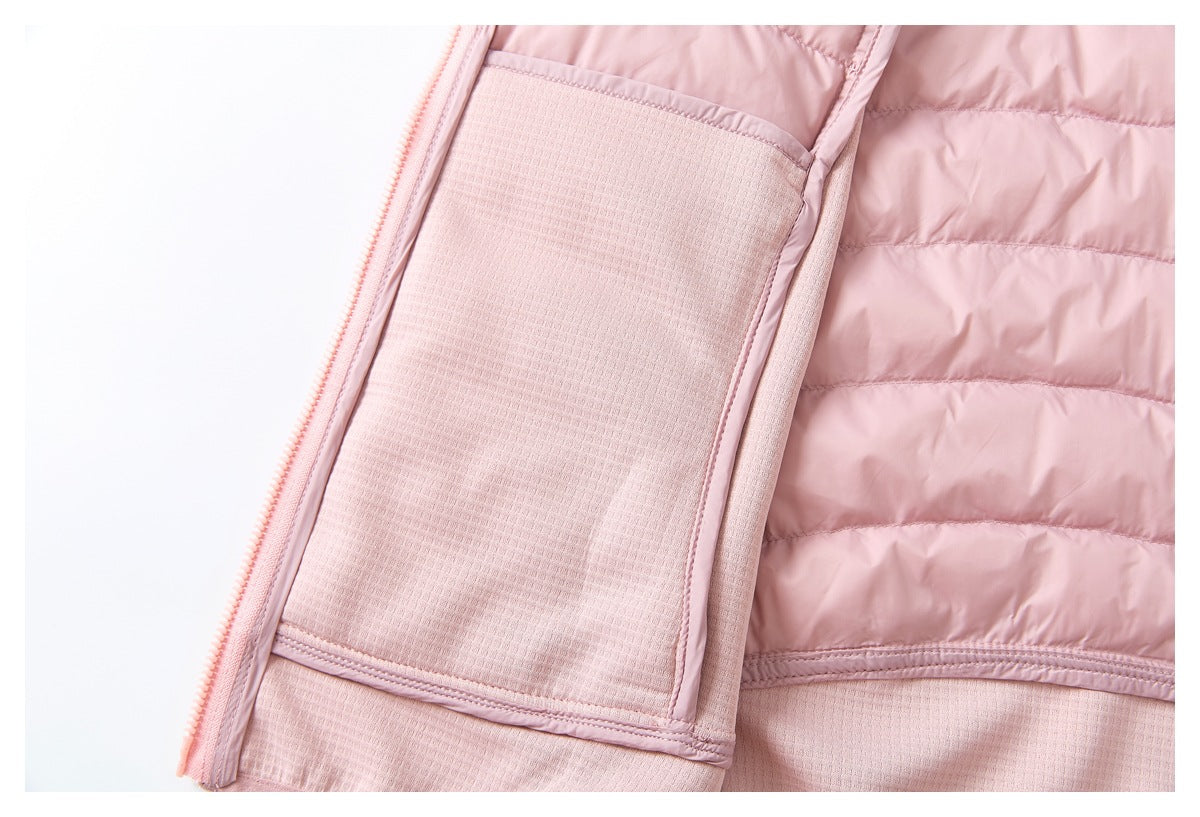 Close-up of a pale pink jacket showing a zipper, quilted lining, and textured fabric panels.