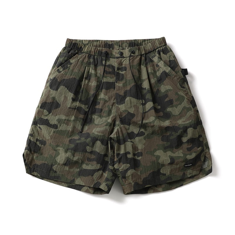 Camouflage knee-length shorts with elastic drawcord waist and side pockets, flat lay front view