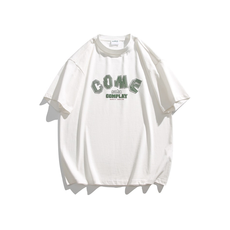 White short-sleeve crew-neck T-shirt with green arched COME COMPLAY graphic on the chest, flat lay