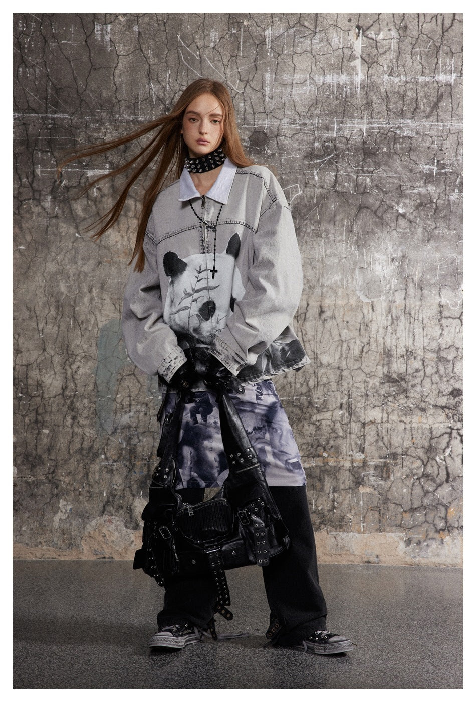 Model wears a light gray panda-print jacket over a purple-gray photo-collage skirt and black trousers.