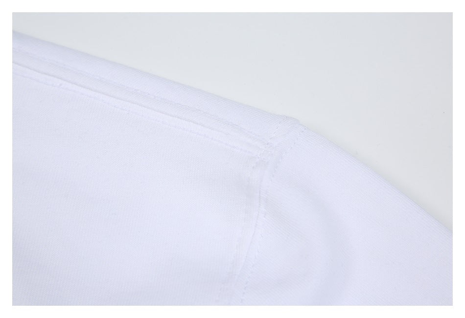 Close-up of the white T-shirt shoulder seam and stitching.