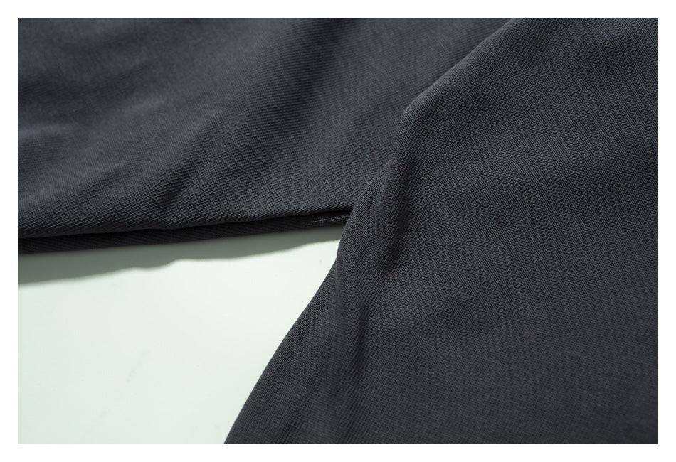 Close-up of the textured surface of dark charcoal fabric.