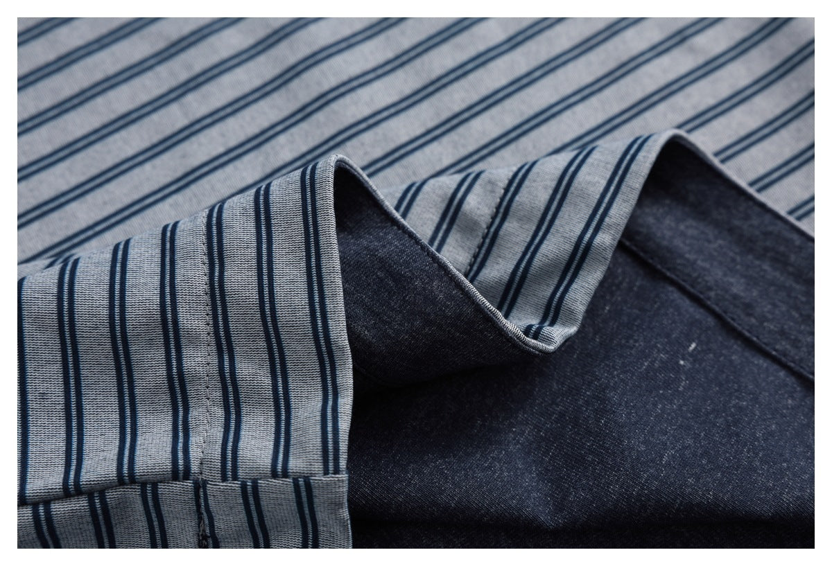 Close-up showing the striped top’s folded edge, seam, and dark reverse side.