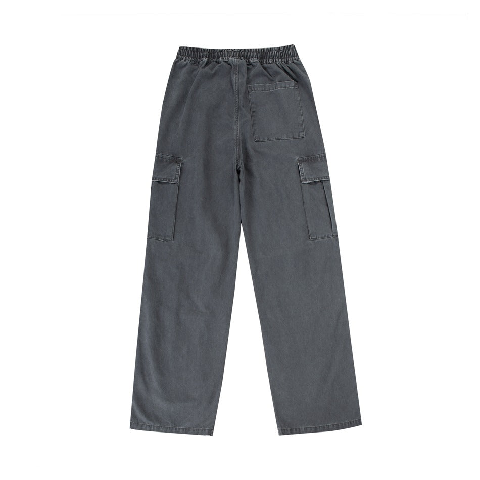 Rear view of charcoal gray wide-leg cargo pants with an elastic waist, one back patch pocket and flap cargo pockets.