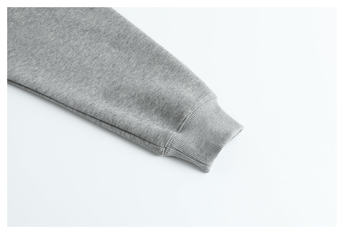 Close-up of a gray sweatshirt sleeve ending in a ribbed cuff.
