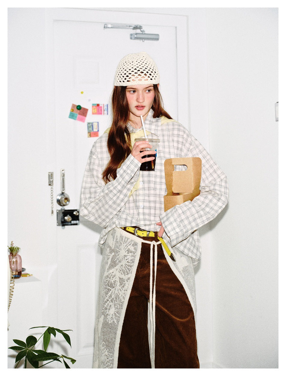 Model in the white checked shirt holding an iced drink and a cardboard carrier, styled with a lace overskirt and corduroy