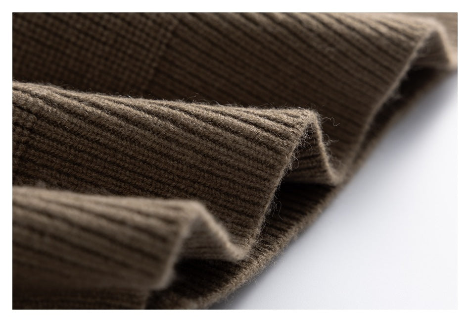 Macro view of the brown cardigan's rib-knit cuff edges and stitching.