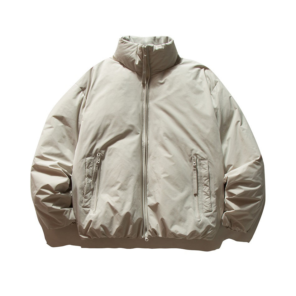 Beige-gray puffer jacket with stand collar, front zipper and two zippered pockets, flat lay front view