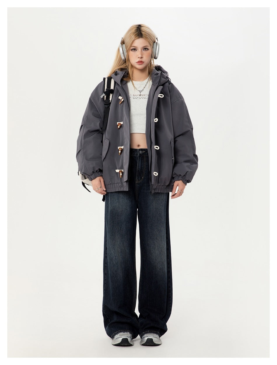 Model wearing the gray toggle hooded jacket open over a cropped top with wide-leg dark jeans, front view
