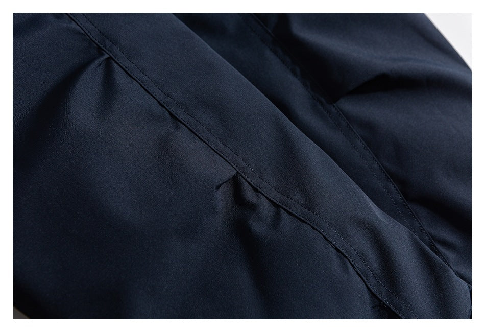 Close-up of navy jacket fabric and stitched panel seams.