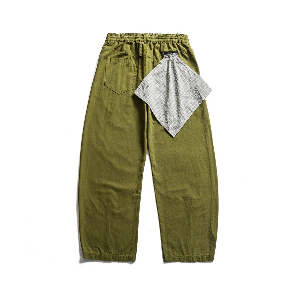 Back view of olive green wide-leg pants with elastic waistband, patch pocket and gray checked cloth at the waist