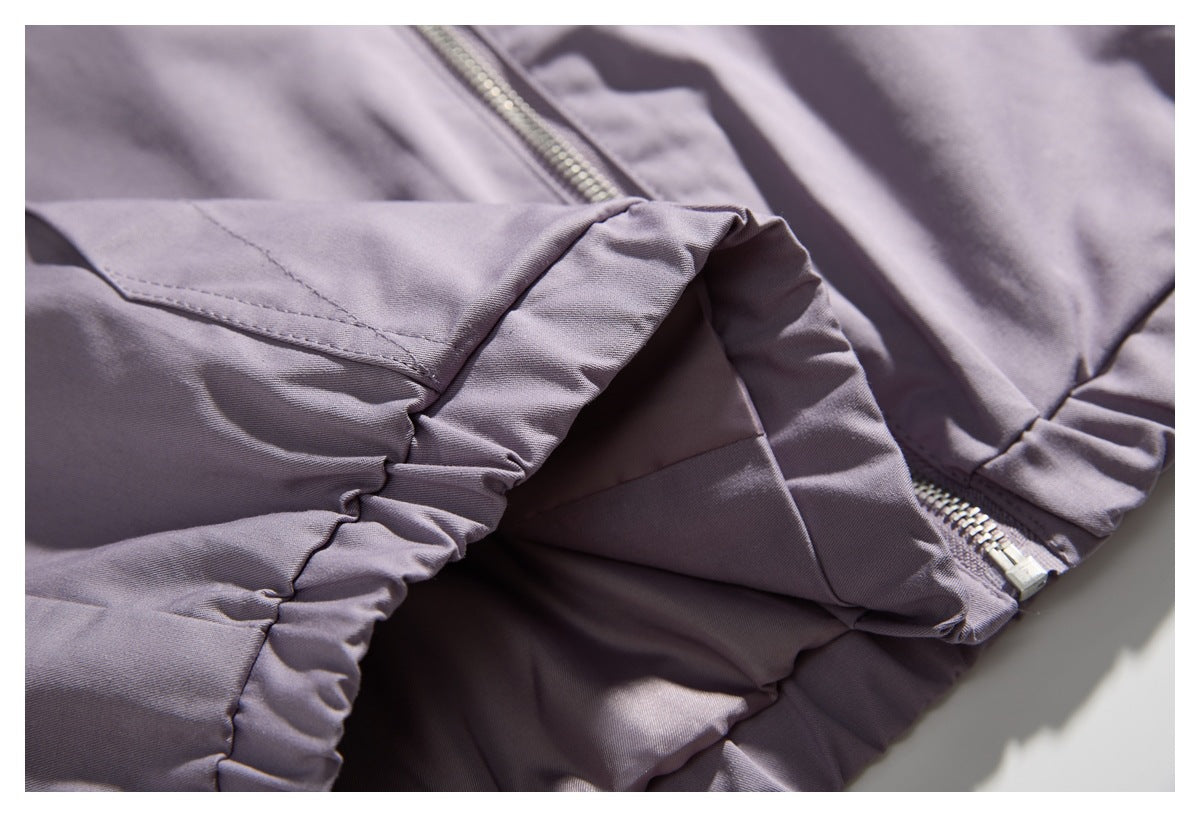 Close-up of the lavender jacket's gathered elastic hem and zipper.