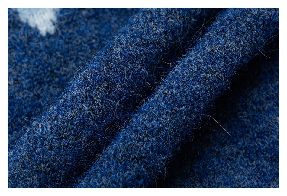 Close-up of fuzzy, mottled blue knit fabric with raised folds.